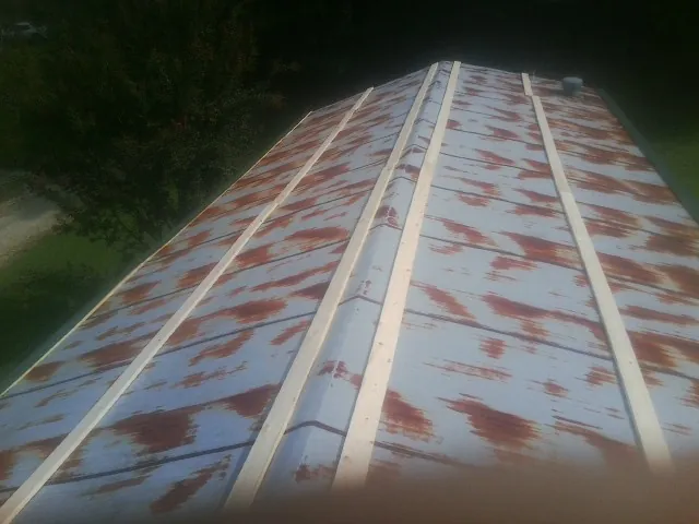 Rusted metal roof panels with new wood purlins before replacement — Storm Damage Roof Repair in Carmichael by Roofing Brothers