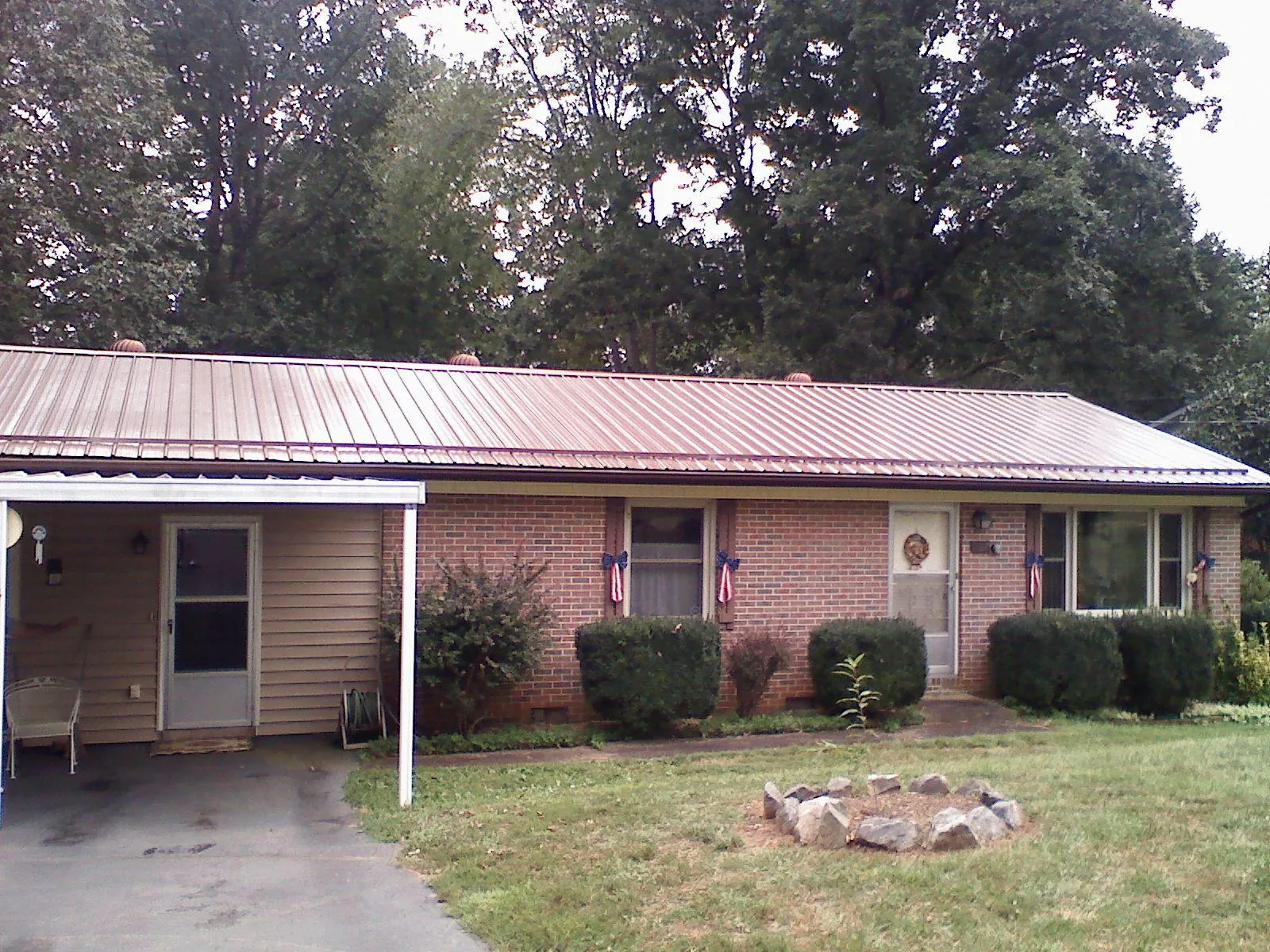 Bronze metal roof and carport on a brick ranch home — Roof Repair work by our crew in Carmichael